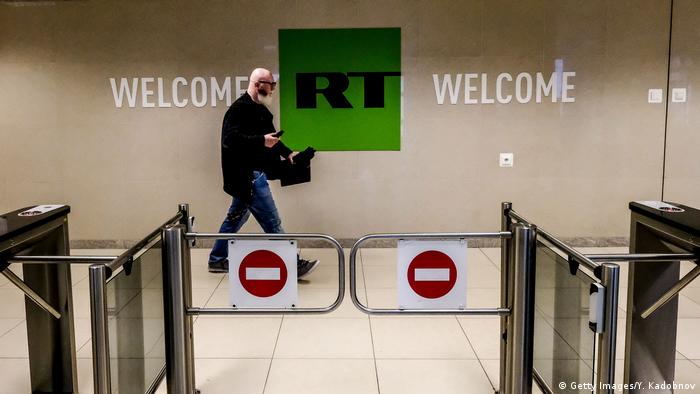  Man walking past a control post of the RT TV company in Moscow