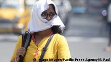 India: Summer heat wave observes in Kolkata Indian Woman covers her face with cloth due to heat wave at hot summer afternoon. Kolkata West Bengal India Kolkata PUBLICATIONxINxGERxSUIxAUTxONLY SaikatxPaul 