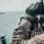 Американский военный наблюдает за иранским военным кораблем в Оманском заливе
