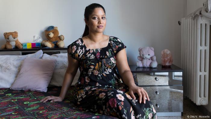 Sahila poses for a portrait in her bedroom