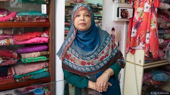 Sultana poses for a portrait in her shop