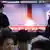 People watch a TV showing a file image of North Korea's missile launch during a news program at the Seoul Railway Station in Seoul