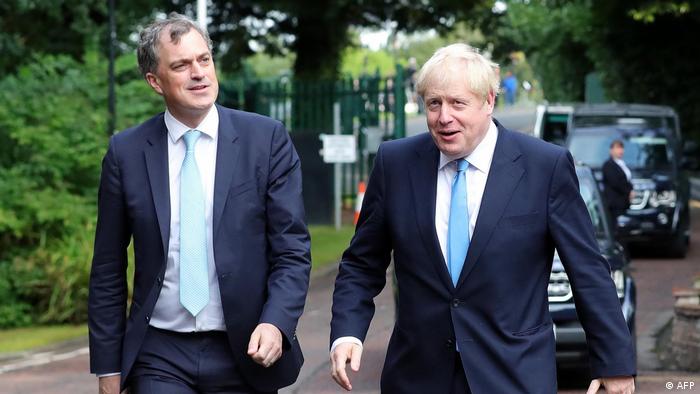 Britain's Northern Ireland Secretary Julian Smith (left) and Britain's Prime Minister Boris Johnson arrive at Stormont in Belfast for talks on July 31, 2019