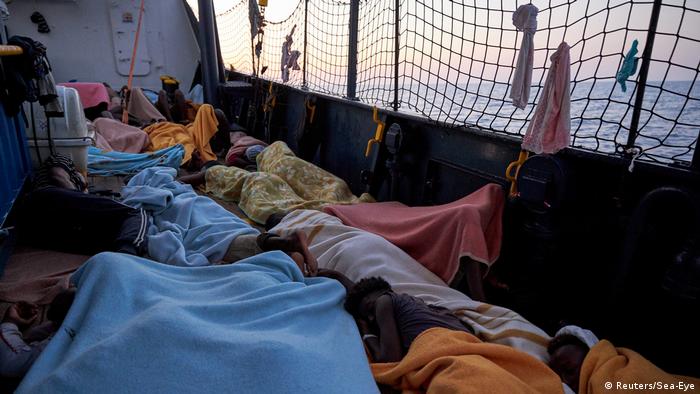 Migrants rest onboard of the NGO Sea-Eye's vessel 'Alan Kurdi'