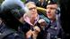 Sobol being held by two Russian officers, one of whom is in riot gear Sobol being held by two Russian officers, one of whom is in riot gear