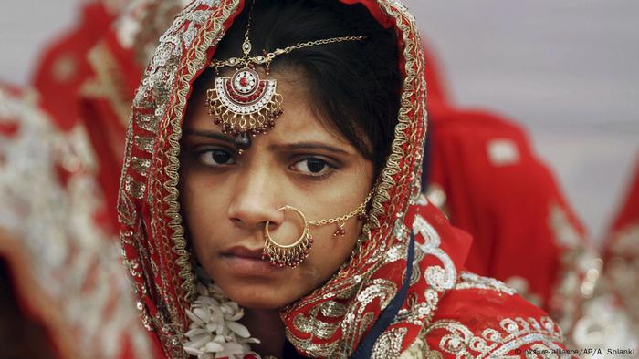 An Indian Muslim bride watches during a mass marriage in Ahmadabad, India