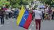 Woman holding Venezuelan flag Woman holding Venezuelan flag