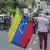 Woman holding Venezuelan flag