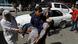 A man carries an injured woman to a hospital after a blast in Kabul A man carries an injured woman to a hospital after a blast in Kabul