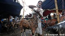 08.08.2019 *** A trader cleans his goat before selling it at a livestock market ahead of the Eid al-Adha festival in the old quarters of Delhi, India August 8, 2019. REUTERS/Adnan Abidi TPX IMAGES OF THE DAY