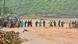 People form a human chain and try to cross muddy flood waters in Kerala, southern India, after a landslide caused by monsoon rain People form a human chain and try to cross muddy flood waters in Kerala, southern India, after a landslide caused by monsoon rain