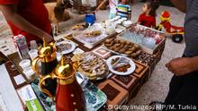 August 10, 2019*** Libyans eat desserts after breaking their fast on the evening prior to the start of the Muslim religious festival of Eid al-Adha in the Libyan capital Tripoli on August 10, 2019. - Known as the big festival, Eid Al-Adha is celebrated each year by Muslims sacrificing various animals according to religious traditions, including cows, camels, goats and sheep. (Photo by Mahmud TURKIA / AFP) (Photo credit should read MAHMUD TURKIA/AFP/Getty Images)