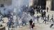 Smoke seen above crowd of people in the Al-Aqsa Mosque compound Smoke seen above crowd of people in the Al-Aqsa Mosque compound