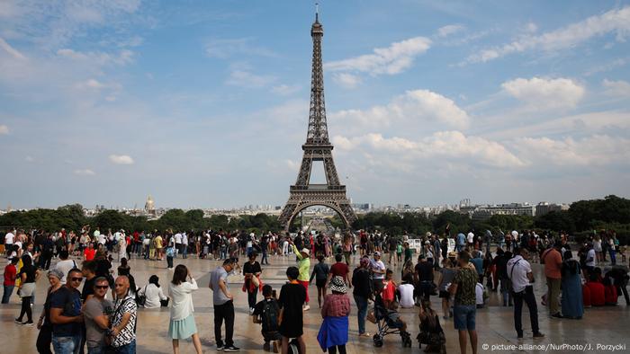Tourists gather at the Place du Trocadero overlooking the Eiffel Tower in Paris, France