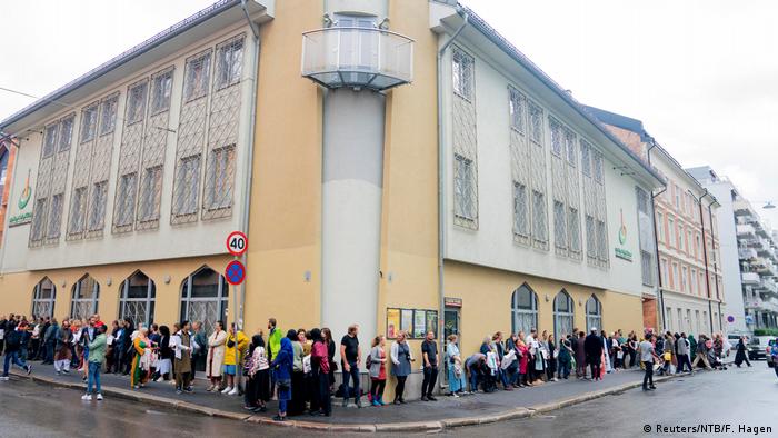 People gather at a mosque in Norway to show solidarity after the shooting.