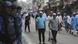 People walk past Indian security forces after prayers in Jammu, India People walk past Indian security forces after prayers in Jammu, India