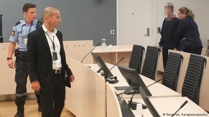Philip Manshaus is escorted into a courtroom in Oslo