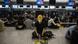 A protester wearing a helmet and mask sitting in front of a check-in counter in Hong Kong International Airport in Hong Kong A protester wearing a helmet and mask sitting in front of a check-in counter in Hong Kong International Airport in Hong Kong