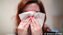 Winter Flu Stock. A woman with a cold blowing her nose with a tissue, in London. URN:34528775 |