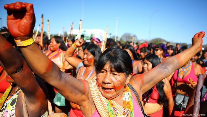 A woman raises her hand in protest