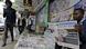 A man reads the daily nation newspaper at a newsstand in Nairobi