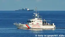 This photo taken on May 14, 2019, a Philippine coast guard ship (R) sails past a Chinese coastguard ship during an joint search and rescue exercise between Philippine and US coastguards near Scarborough shoal, in the South China Sea. - Two Philippine coastguard ships, BRP Batangas and Kalanggaman and US coastguard cutter Bertholf participated in the exercise. (Photo by TED ALJIBE / AFP) (Photo credit should read TED ALJIBE/AFP/Getty Images)