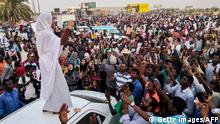 Alaa Salah, a Sudanese woman propelled to internet fame earlier this week after clips went viral of her leading powerful protest chants against President Omar al-Bashir, addresses protesters during a demonstration in front of the military headquarters in the capital Khartoum on April 10, 2019. - In the clips and photos, the elegant Salah stands atop a car wearing a long white headscarf and skirt as she sings and works the crowd, her golden full-moon earings reflecting light from the fading sunset and a sea of camera phones surrounding her. Dubbed online as Kandaka, or Nubian queen, she has become a symbol of the protests which she says have traditionally had a female backbone in Sudan. (Photo by - / AFP) (Photo credit should read -/AFP/Getty Images)
