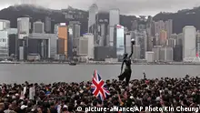 In this Sunday, July 7, 2019, photo, thousands of protesters carrying the British flag march near the harbor of Hong Kong. Hong Kong police on Tuesday confirmed it had received a report on Aug. 9, 2019, about a British foreign ministry employee who has been missing since crossing into China on a business trip. Local media reports have identified the missing man as Simon Cheng Man-kit, a trade and investment officer at the Scottish Development International section of the consulate. (AP Photo/Kin Cheung) |