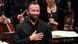 Kirill Petrenko with orchestra members seen in background Kirill Petrenko with orchestra members seen in background