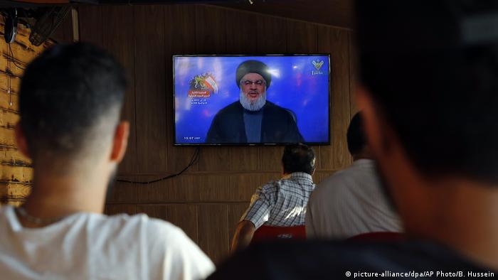 People watch Hassan Nasrallah speak on TV on August 25, 2019