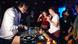 A DJ playing music in a club A DJ playing music in a club