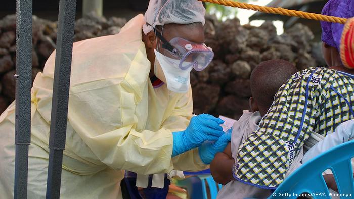 A nurse in Congo vaccinating a child against Ebola.