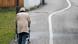 Elderly person walking down a street Elderly person walking down a street
