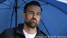 FILE - In this April 27, 2019 file photo, Christoph Metzelder watches under an umbrella in the stadium in Dortmund, Germany, Saturday, April 27, 2019. The Hamburg public prosecutor's office investigates against the former German national player and defender for Borussia Dortmund and Real Madrid in a case of spreading child abuse images. (AP Photo/Martin Meissner) |