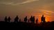 Refugees from the Middle East are silhouetted against the setting sun as they walk on railway tracks from Serbia Refugees from the Middle East are silhouetted against the setting sun as they walk on railway tracks from Serbia