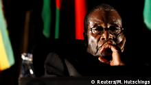 FILE PHOTO: Zimbabwean President Robert Mugabe watches a video presentation during the summit of the Southern African Development Community (SADC) in Johannesburg, August 17, 2008. REUTERS/Mike Hutchings/File Photo TPX IMAGES OF THE DAY