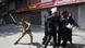 An Indian police officer beats Kashmiri Shiite Muslims as they attempt to take out a religious procession during restrictions in Srinagar An Indian police officer beats Kashmiri Shiite Muslims as they attempt to take out a religious procession during restrictions in Srinagar