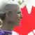 Catherine McKenna with the Canadian flag