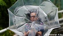 A woman using an umbrella struggles against a heavy rain and wind caused by Typhoon Faxai in Tokyo, Japan September 9, 2019. REUTERS/Issei Kato 