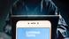 A Goldman Sachs logo can be seen on a phone screen. A Goldman Sachs logo can be seen on a phone screen.