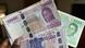 Hand holds various CFA franc notes Hand holds various CFA franc notes