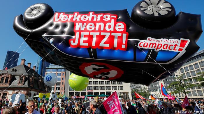Protestors gather outside the Frankfurt exhibition hall with a car-shaped balloon (Reuters/W. Rattay)