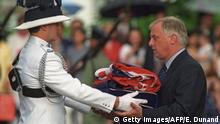 30.06.1997 Hong Kong, HONG KONG: TO GO WITH AFP STORY by LOIC VENNIN - FILES - Chris Patten (R), the 28th and last governor of colonial Hong Kong, receives the Union Jack flag after is was lowered for the last time at Government House - the governor's official residence - during a farewell ceremony in Hong Kong, 30 June 1997, just hours prior to the end of some 156 years of British colonial rule as the territory returns to Chinese control at midnight. China's southern coast prepares to mark the 10th anniversary of it's return to Chinese rule on July 1, 1997. AFP PHOTO / FILES / EMMANUEL DUNAND (Photo credit should read EMMANUEL DUNAND/AFP/Getty Images)