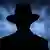 Silhouette of a mysterious man in a vintage style wide brimmed hat