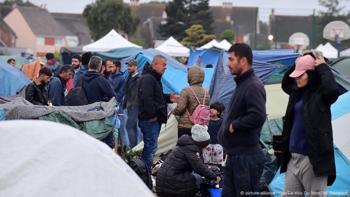 Migrants in tent camp evacuated by police Migrants in tent camp evacuated by police