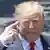 President Donald Trump points to his brain as he makes a derogatory remark against former Vice President and 2020 Democratic presidential candidate Joe Biden