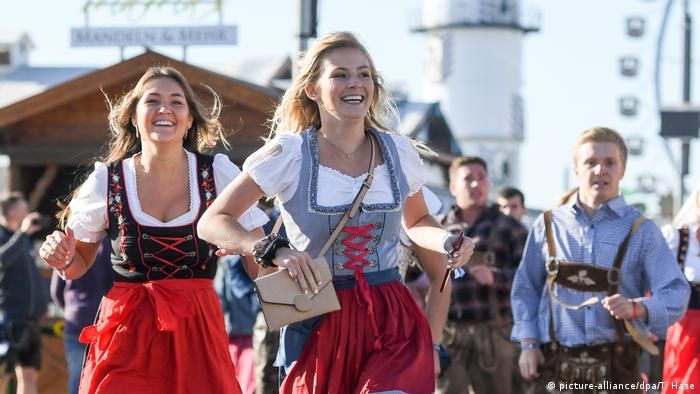 Tens of thousands of people stormed the Oktoberfest beer festival grounds on Saturday after organizers opened the gates in the German city of Munich