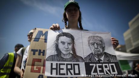 Greta Thunberg and Donald Trump faces on a placard at an environmental protest in Italy 
