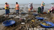 In this photograph taken on September 14, 2019 city civil authority workers pick up plastic waste and trash during a clean-up drive on Versova beach in Mumbai. - Facing severe flooding as sea levels rise, authorities in India's financial capital Mumbai are building bunds and restoring coastal mangrove trees to protect the vulnerable mega-city. (Photo by PUNIT PARANJPE / AFP) / TO GO WTIH: UN-climate-India-science-oceans-Mumbai, FOCUS by Vishal MANVE (Photo credit should read PUNIT PARANJPE/AFP/Getty Images)