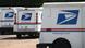 USPS trucks with the postal service logo sit in a parking lot USPS trucks with the postal service logo sit in a parking lot
